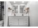 Bright bathroom with double vanity, framed mirrors, sleek fixtures, and stone tiled shower at 1408 126Th St, Carmel, IN 46033