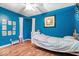 Bedroom featuring hardwood floors, blue walls and a ceiling fan at 1408 126Th St, Carmel, IN 46033