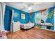 Bedroom featuring hard wood floors, a colorful painted wall, a ceiling fan and natural light at 1408 126Th St, Carmel, IN 46033