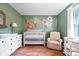 Beautiful Bedroom with wood floors, white trim, crib, and stylish floral wall art at 1408 126Th St, Carmel, IN 46033