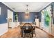 The dining room has stylish lighting, dark blue walls, natural light and seating for six at 1408 126Th St, Carmel, IN 46033