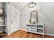 Inviting entryway features wood floors, a vaulted ceiling, and a convenient white console table with mirror at 1408 126Th St, Carmel, IN 46033