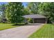 Charming one-story home with a brick facade, attached garage, and mature trees at 1408 126Th St, Carmel, IN 46033
