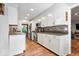 Bright kitchen with white cabinets, stainless appliances, mosaic backsplash, and wood floors at 1408 126Th St, Carmel, IN 46033