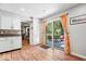 Sun-drenched kitchenette featuring modern cabinets, a pantry, and sliding glass doors to a patio at 1408 126Th St, Carmel, IN 46033