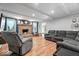 Inviting living room features a brick fireplace, comfortable seating, and hardwood floors at 1408 126Th St, Carmel, IN 46033