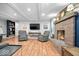 Inviting living room features a brick fireplace, wood floors, neutral walls, and comfortable seating at 1408 126Th St, Carmel, IN 46033