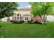 Backyard featuring well-manicured lawn, mature trees, and a patio area ideal for outdoor relaxation and entertaining at 14662 Woodstone Cir, Fishers, IN 46037