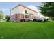 Spacious backyard with lush green lawn, landscaping, and a patio area perfect for outdoor gatherings and leisure at 14662 Woodstone Cir, Fishers, IN 46037