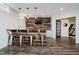 Finished basement with a modern bar area featuring wood paneling, granite counters, and stylish metal stools at 14662 Woodstone Cir, Fishers, IN 46037