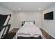 Cozy basement bedroom featuring a bed, TV, and a treadmill for exercise at 14662 Woodstone Cir, Fishers, IN 46037