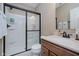 Modern bathroom with a glass-enclosed shower, stylish vanity, and neutral color scheme at 14662 Woodstone Cir, Fishers, IN 46037