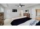 Well-lit bedroom showcasing a tray ceiling, a ceiling fan, and carpeted floors at 14662 Woodstone Cir, Fishers, IN 46037