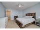 Bedroom with rustic wood bedframe, white dresser, and desk offering functionality and style at 14662 Woodstone Cir, Fishers, IN 46037