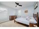 Cozy bedroom with natural light featuring a spindle bed, dark wooden dresser, and ceiling fan at 14662 Woodstone Cir, Fishers, IN 46037