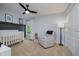 Bright Bedroom featuring a modern crib, comfortable glider, and soft lighting, creating a serene atmosphere at 14662 Woodstone Cir, Fishers, IN 46037