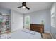 Bedroom with a double bed, dresser, white closet doors, and a window overlooking the yard at 14662 Woodstone Cir, Fishers, IN 46037