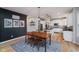 Open-concept dining area showcasing the hardwood floors and kitchen with stainless steel appliances at 14662 Woodstone Cir, Fishers, IN 46037