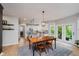 Bright dining area with wooden table, chairs, and views to the kitchen and outdoors at 14662 Woodstone Cir, Fishers, IN 46037