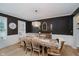 Formal dining room with rustic wooden table, decorative lighting, and wainscoting at 14662 Woodstone Cir, Fishers, IN 46037