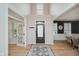 Bright foyer features hardwood floors, a statement rug, and seamless transition to living areas at 14662 Woodstone Cir, Fishers, IN 46037