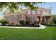 Stunning brick home with a landscaped front yard, inviting porch, and classic architectural details at 14662 Woodstone Cir, Fishers, IN 46037