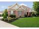 Well-manicured lawn and landscaping enhance this brick home's curb appeal at 14662 Woodstone Cir, Fishers, IN 46037