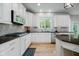Bright kitchen with white cabinets, subway tile backsplash, stainless steel appliances, and dark counters at 14662 Woodstone Cir, Fishers, IN 46037