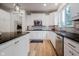 Modern kitchen with granite counters, white cabinetry, stainless steel appliances, and tile backsplash at 14662 Woodstone Cir, Fishers, IN 46037