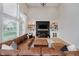 Stylish living room with large windows, fireplace, custom built-ins, and comfortable seating at 14662 Woodstone Cir, Fishers, IN 46037