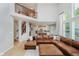 Spacious open-concept living area with leather sectional, high ceilings, and hardwood floors at 14662 Woodstone Cir, Fishers, IN 46037