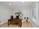 Well-lit home office with hardwood floors, desk, and built-in shelving at 14662 Woodstone Cir, Fishers, IN 46037