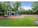 Community playground featuring play structures, swings, and a cushioned ground cover, offering a fun and safe area for children at 14662 Woodstone Cir, Fishers, IN 46037