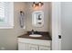 Half bathroom featuring a vanity with a granite countertop and framed mirror at 14662 Woodstone Cir, Fishers, IN 46037