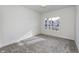 Bright bedroom features neutral carpet, white walls, and a window with a view of the neighborhood at 14844 Higgins Dr, Westfield, IN 46074