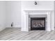 Close-up shot of a modern gas fireplace with white mantle and dark gray tile at 14844 Higgins Dr, Westfield, IN 46074