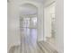 Hallway showcasing new light wood floors, an arched entry, a bathroom, and access to the outdoor living space at 14844 Higgins Dr, Westfield, IN 46074