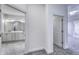 Neutral hallway leads to a bathroom, featuring a double vanity with marble countertop at 14844 Higgins Dr, Westfield, IN 46074