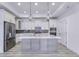 Bright kitchen features an island with quartz countertop, stainless steel appliances, and pendant lighting at 14844 Higgins Dr, Westfield, IN 46074