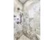 Beautiful shower features marble tiling, multiple shower heads, and a built-in bench at 14844 Higgins Dr, Westfield, IN 46074