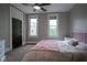 Bright bedroom featuring two windows, a ceiling fan, and neutral carpet at 1512 Bellefontaine St, Indianapolis, IN 46202