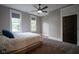 Bedroom with neutral walls, two windows, ceiling fan and plush carpet at 1512 Bellefontaine St, Indianapolis, IN 46202
