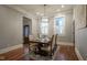 Elegant dining room featuring a modern chandelier, hardwood floors and a large dining table at 1512 Bellefontaine St, Indianapolis, IN 46202