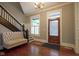 Welcoming foyer with hardwood floors, staircase, bench seating and natural light at 1512 Bellefontaine St, Indianapolis, IN 46202