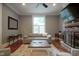 Bright living room with hardwood floors, fireplace, and large window with plantation shutters at 1512 Bellefontaine St, Indianapolis, IN 46202