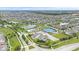 Aerial view of the residential community showcasing a clubhouse, pool, tennis courts, and scenic ponds at 1655 Avondale Dr, Westfield, IN 46074