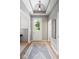 Bright foyer featuring decorative lighting, wood flooring, and neutral paint at 1655 Avondale Dr, Westfield, IN 46074
