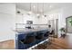 Bright kitchen with white cabinets, large island, and modern pendant lighting at 1655 Avondale Dr, Westfield, IN 46074