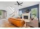 Elegant living room featuring hardwood floors, fireplace, a stylish couch and staircase at 1655 Avondale Dr, Westfield, IN 46074