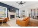 Bright living room with a fireplace, plush seating, hardwood floors and a ceiling fan at 1655 Avondale Dr, Westfield, IN 46074